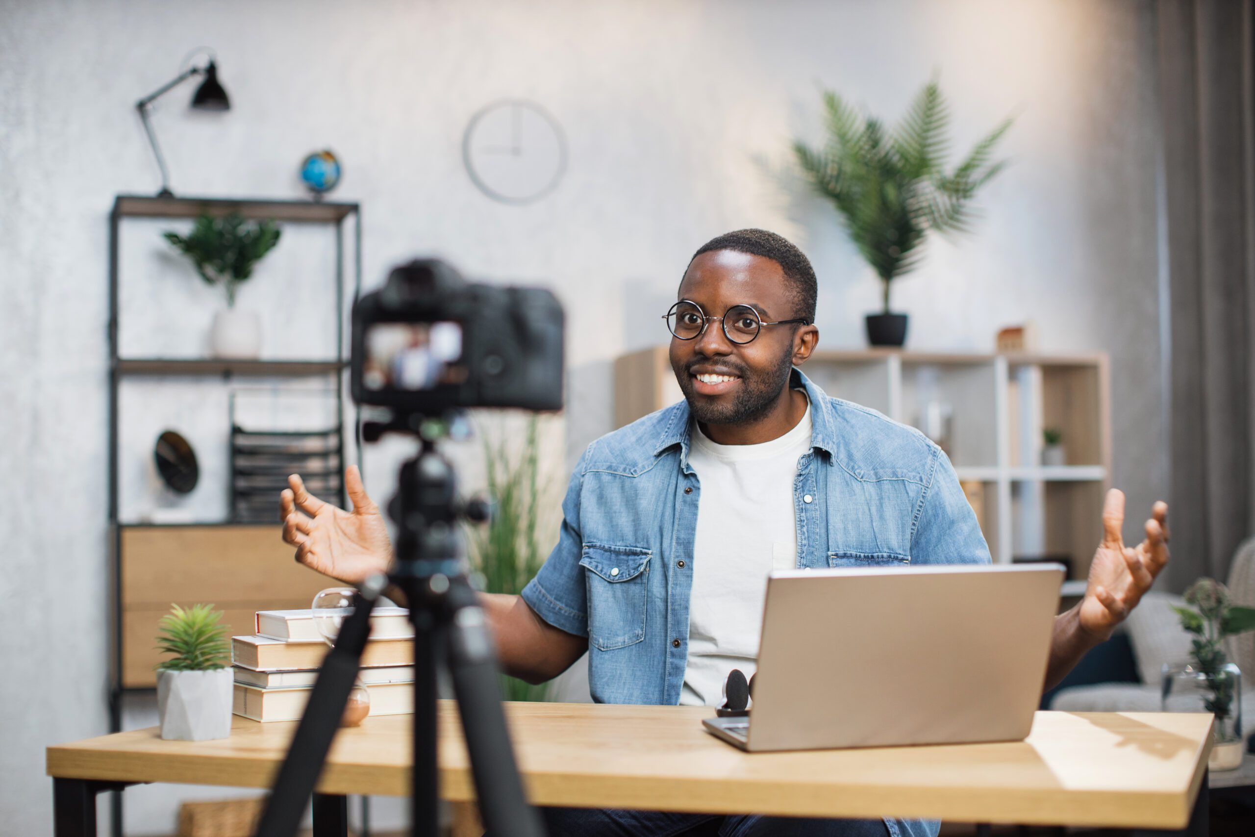 Freelancer using camera and laptop to film a podcast episode